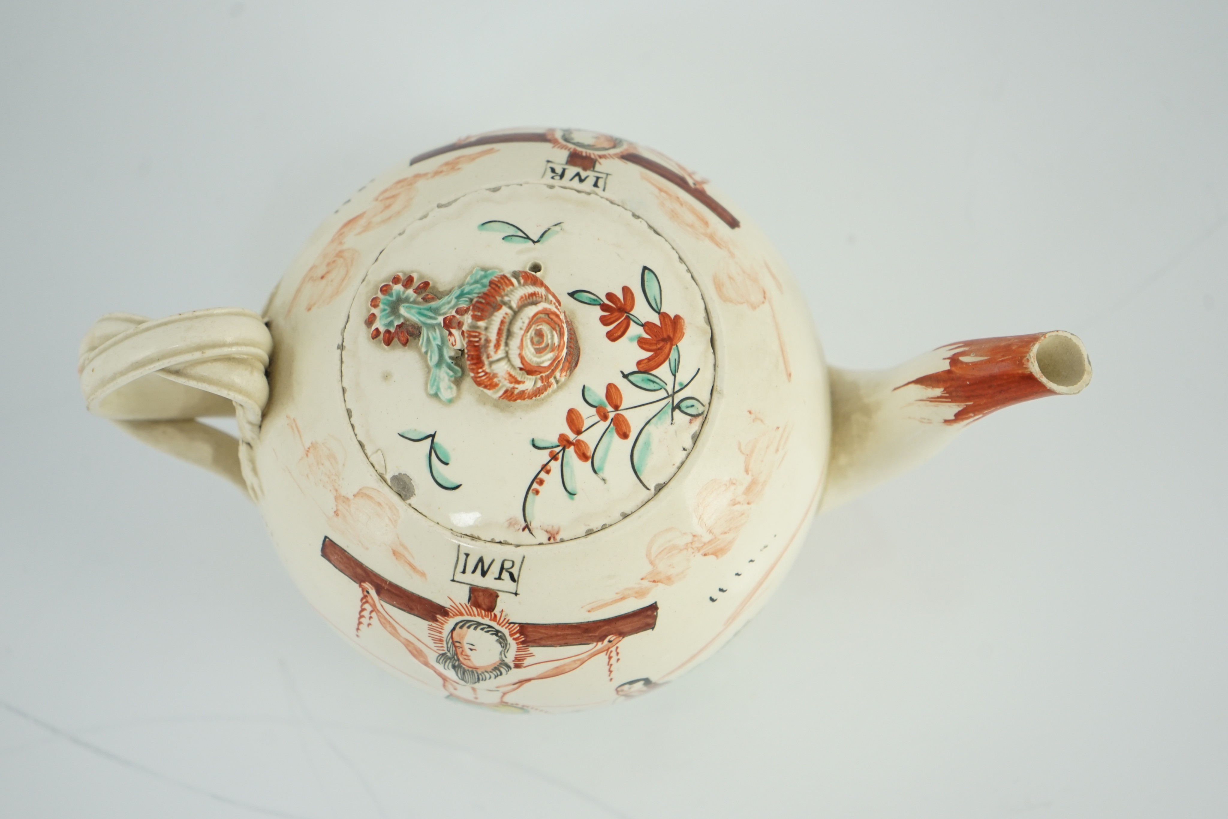 A rare English creamware ‘crucifixion’ teapot, c.1780-1800, 20cm spout to handle, tiny chips